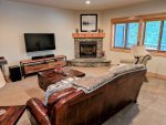 Enjoy TV or movies by the fireplace on the large flat screen TV